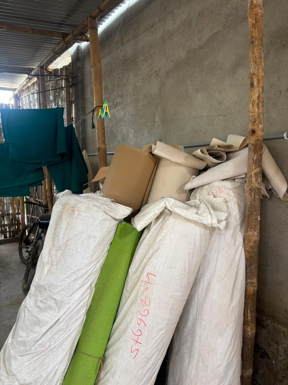 Raw jute and cotton fabric rolls in storage